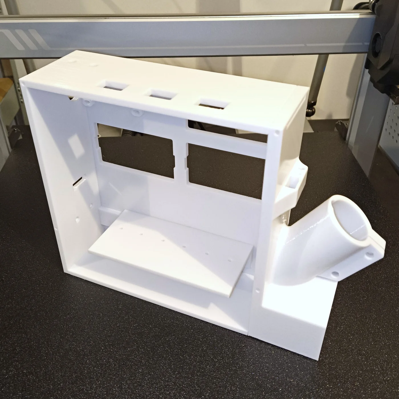 White 3D-printed feeder enclosure prototype